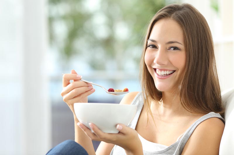 veganly vitamins Woman-eating-cornflakes-at-home
